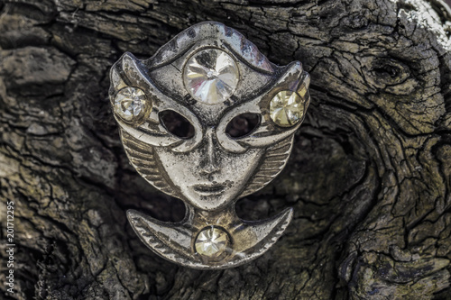 Old alien face mask on old wood closeup