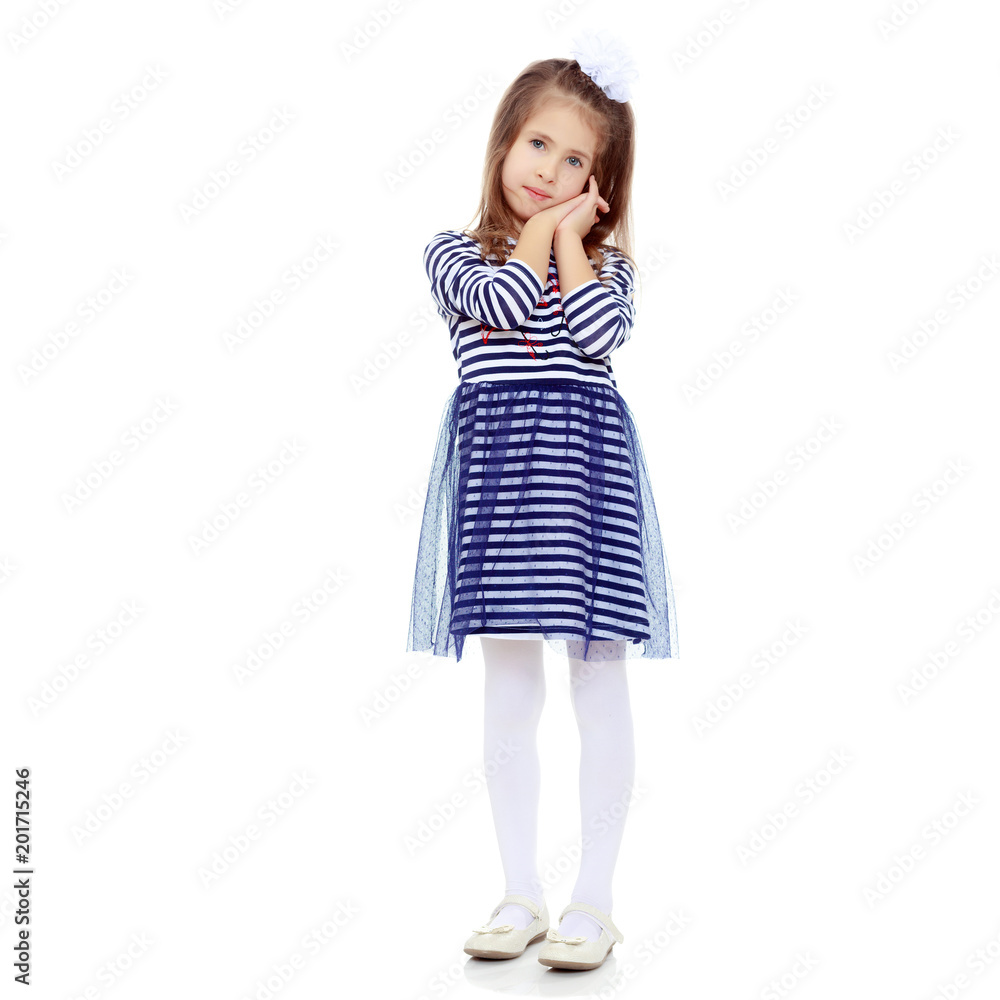 Cute little girl posing in front of the camera. Cute little girl posing in front of the camera.