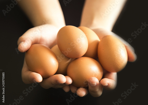eggs in hand with black background 