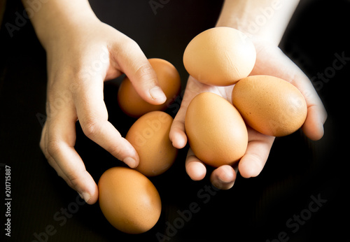 eggs in hand with black background 