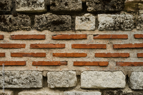 Closeup background photo. Ancient Roman bricklaying. Two types of bricks are used.