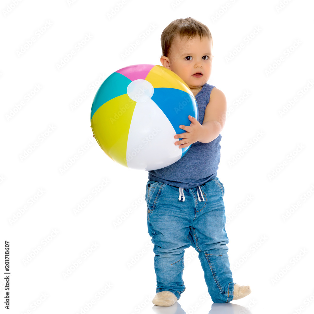 A little boy is playing with a ball. A little boy is playing with a ball.