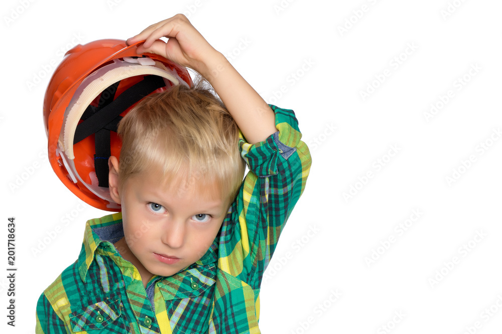The little boy in the helmet of the builder. The little boy in the helmet of the builder.