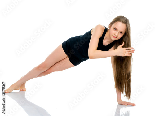 The gymnast perform an acrobatic element on the floor.