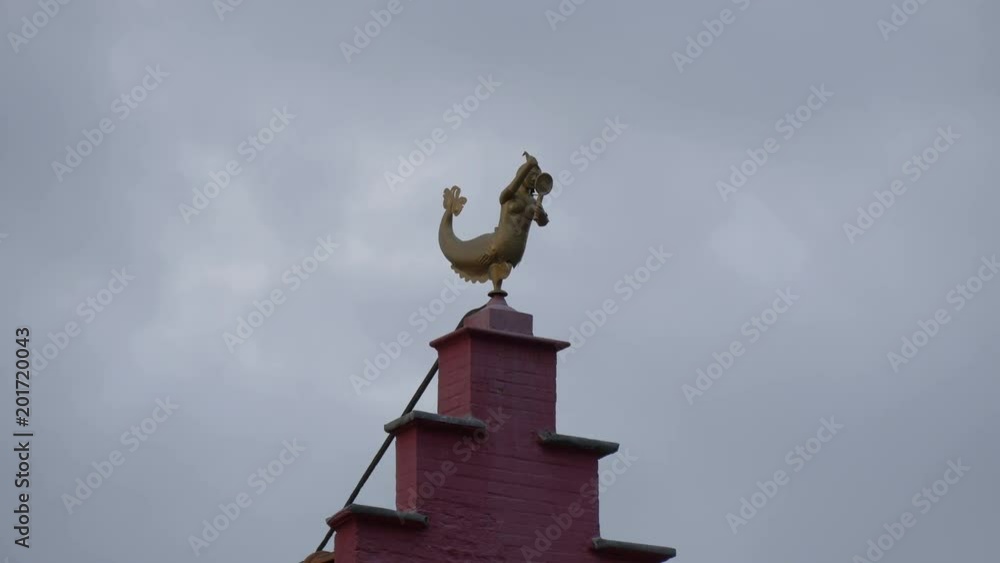 Golden mermaid statue on top of a building Golden mermaid statue on top of a building