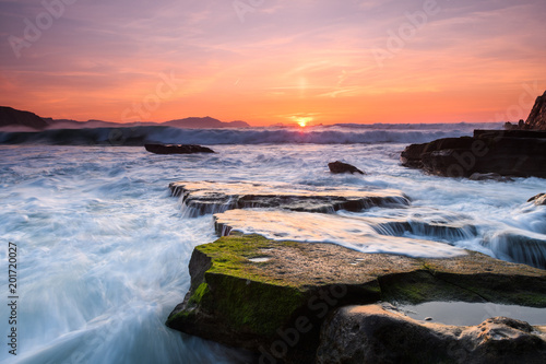 amazing sunset landscape at rocky beach © jon_chica