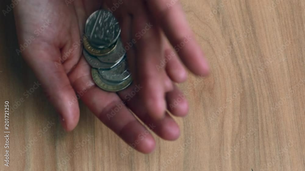 Counting and playing with british pounds in the hands on the floor background, illustration for brexit and economics Counting and playing with british pounds in the hands on the floor background, illustration for brexit and economics