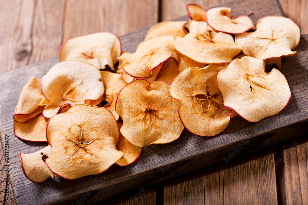 Fototapeta premium dried apples on wooden board