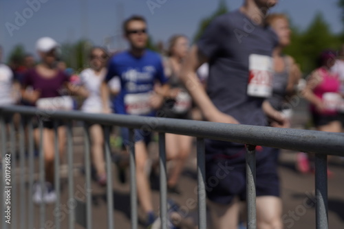 Marathon barrier with blurred people running in the background