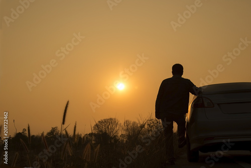 one man and the car with a trip before sunset.