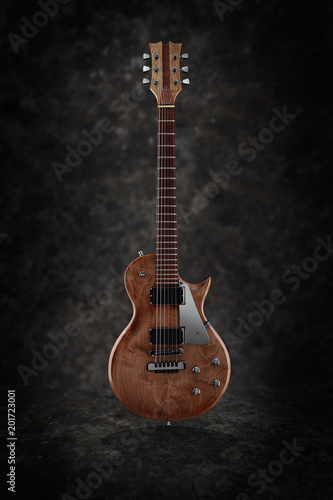 Electric guitar with natural finish isolated on dark grunge background, low key © mikelaptev