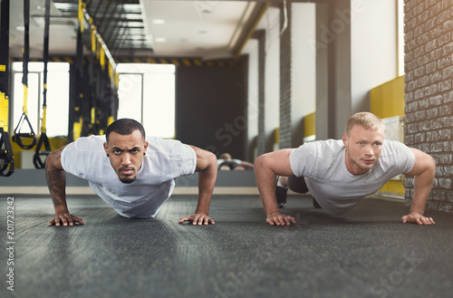 Two men fitness workout, push ups or plank photo