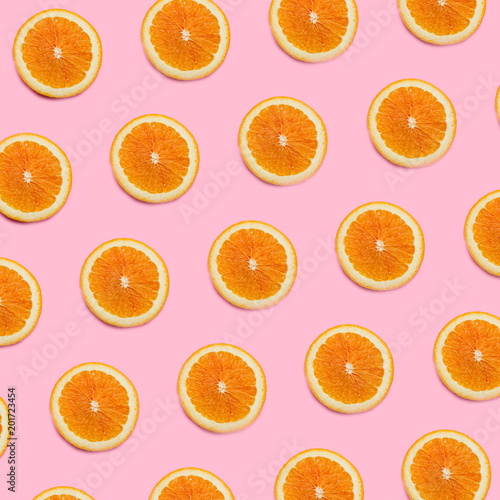 Fresh orange pattern on a vivid pink background flat lay