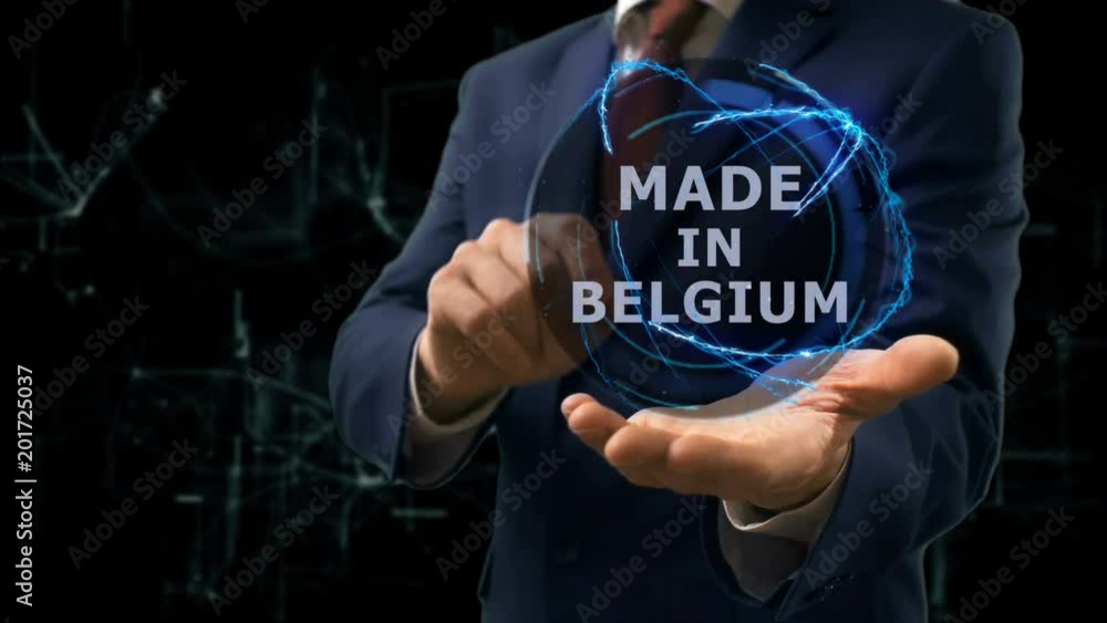 Businessman shows concept hologram Made in Belgium on his hand. Man in business suit with future technology screen and modern cosmic background Businessman shows concept hologram Made in Belgium on his hand. Man in business suit with future technology screen and modern cosmic background
