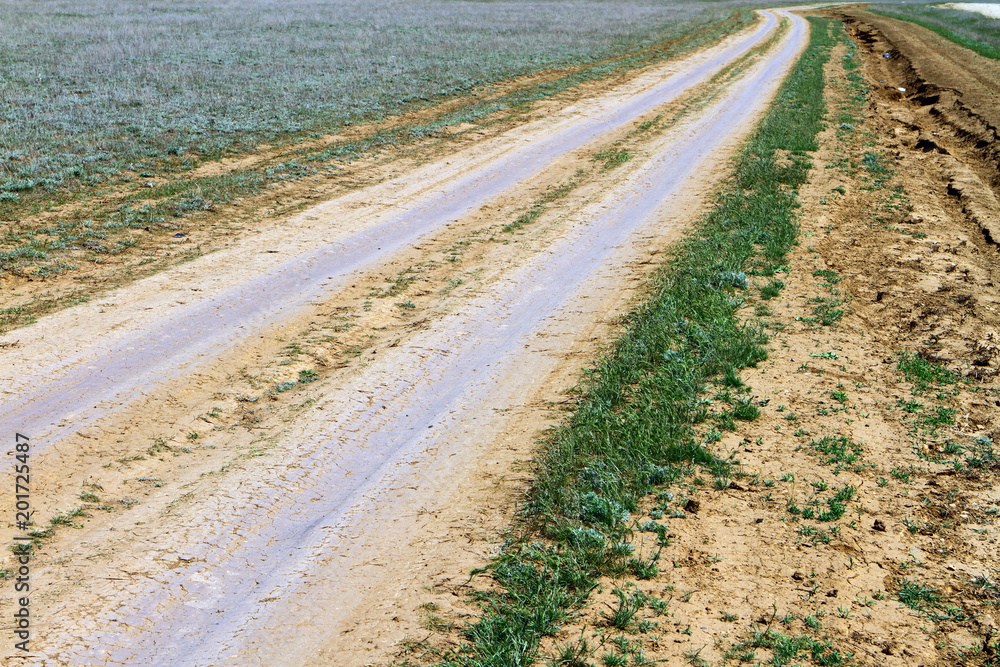 Unpaved dry dirt country road in steppe, offroad drive Unpaved dry dirt country road in steppe, offroad drive