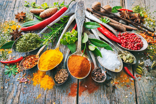 Fototapeta Naklejka Na Ścianę i Meble -  Various herbs and spices with spoons