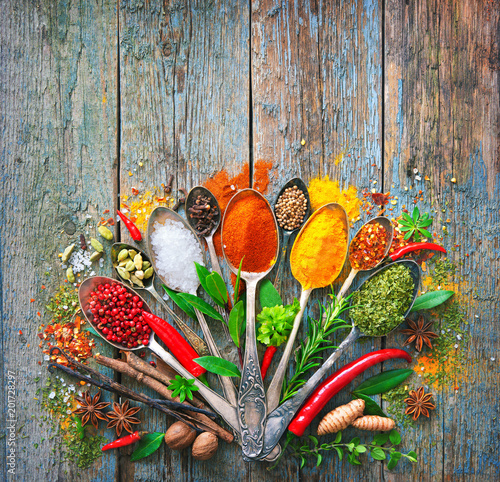 Fototapeta Naklejka Na Ścianę i Meble -  Various herbs and spices with spoons