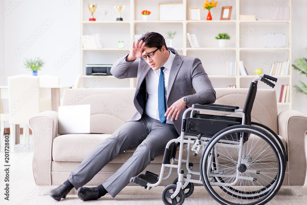 Dsabled businessman on wheelchair working home Dsabled businessman on wheelchair working home