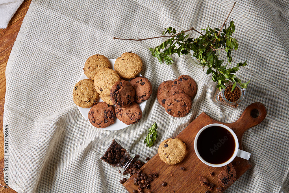 Breakfast background with mug of fresh coffee, homemade oatmeal cookies, grind coffee Breakfast background with mug of fresh coffee, homemade oatmeal cookies, grind coffee