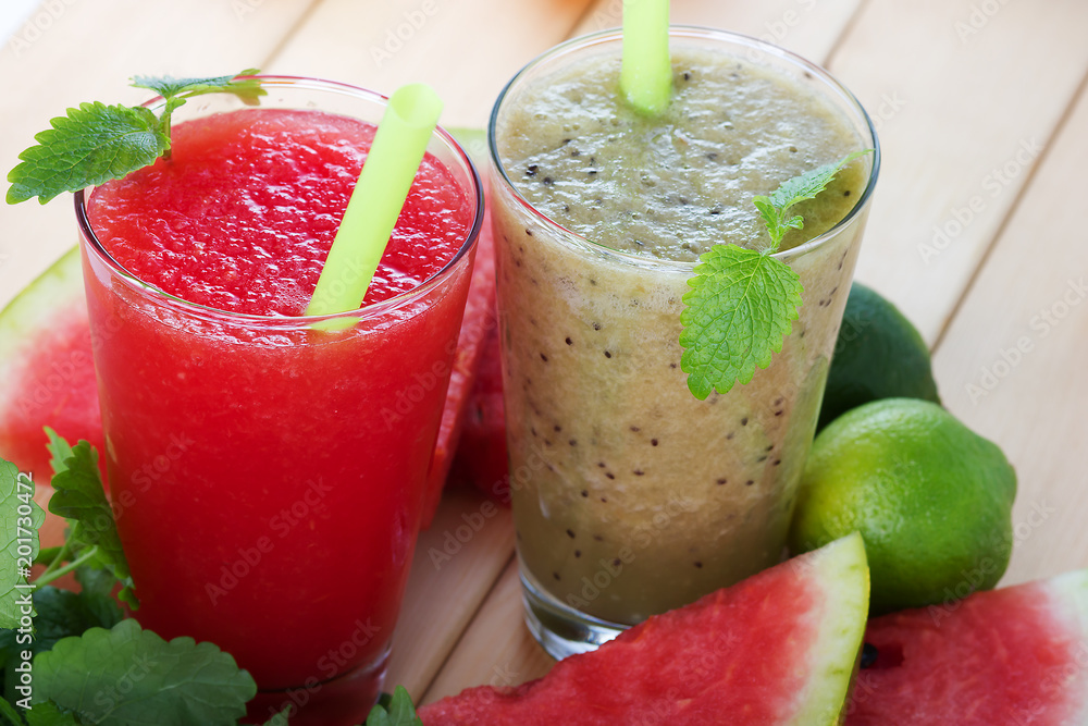 Smoothie of banana and kiwi smoothie and watermelon with mint on wooden background Smoothie of banana and kiwi smoothie and watermelon with mint on wooden background