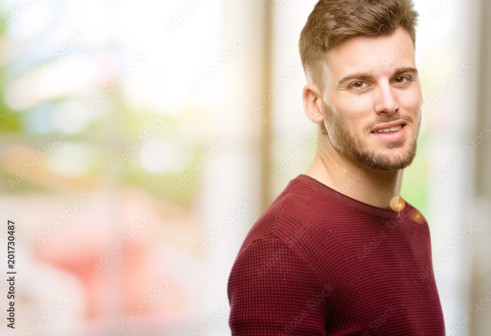 Handsome young man confident and happy with a big natural smile laughing Handsome young man confident and happy with a big natural smile laughing