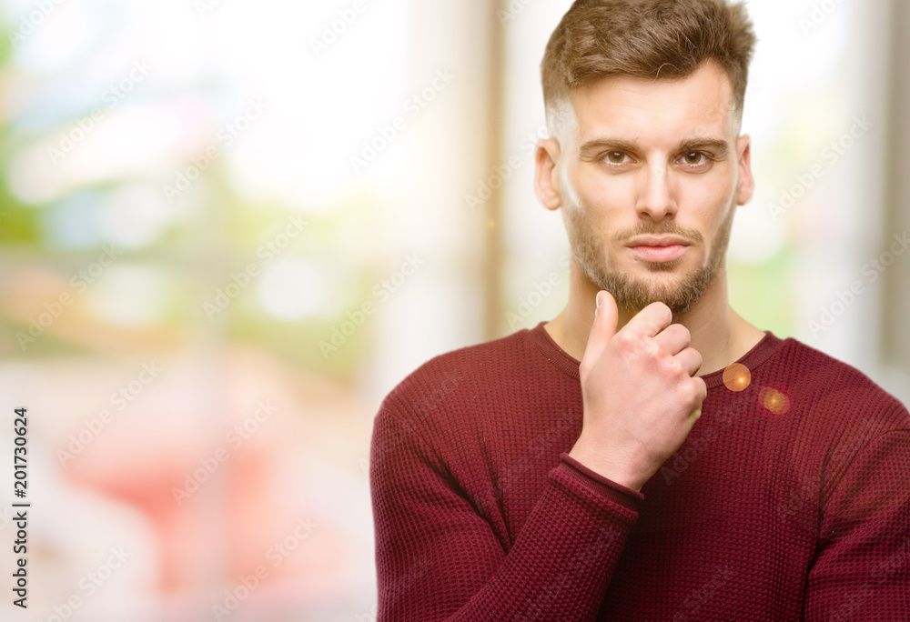 Handsome young man with crossed arms confident and serious Handsome young man with crossed arms confident and serious
