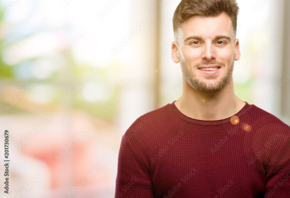 Handsome young man confident and happy with a big natural smile laughing Handsome young man confident and happy with a big natural smile laughing