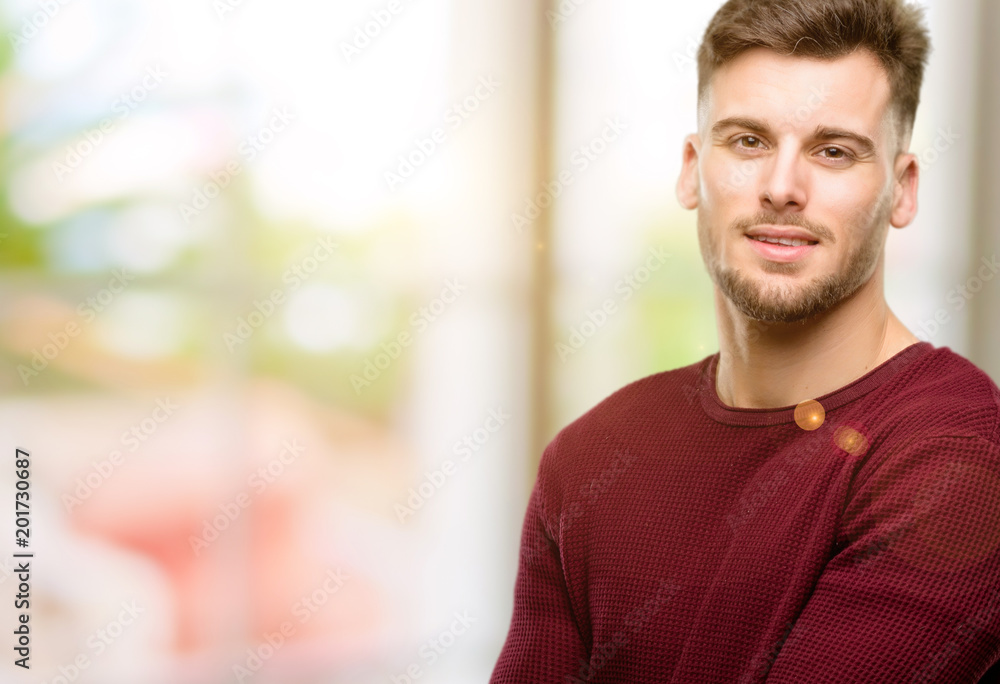 Handsome young man confident and happy with a big natural smile laughing Handsome young man confident and happy with a big natural smile laughing