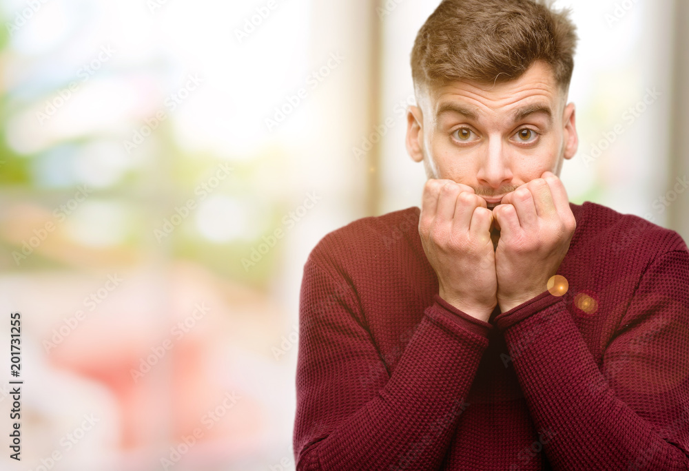Handsome young man terrified and nervous expressing anxiety and panic gesture, overwhelmed Handsome young man terrified and nervous expressing anxiety and panic gesture, overwhelmed
