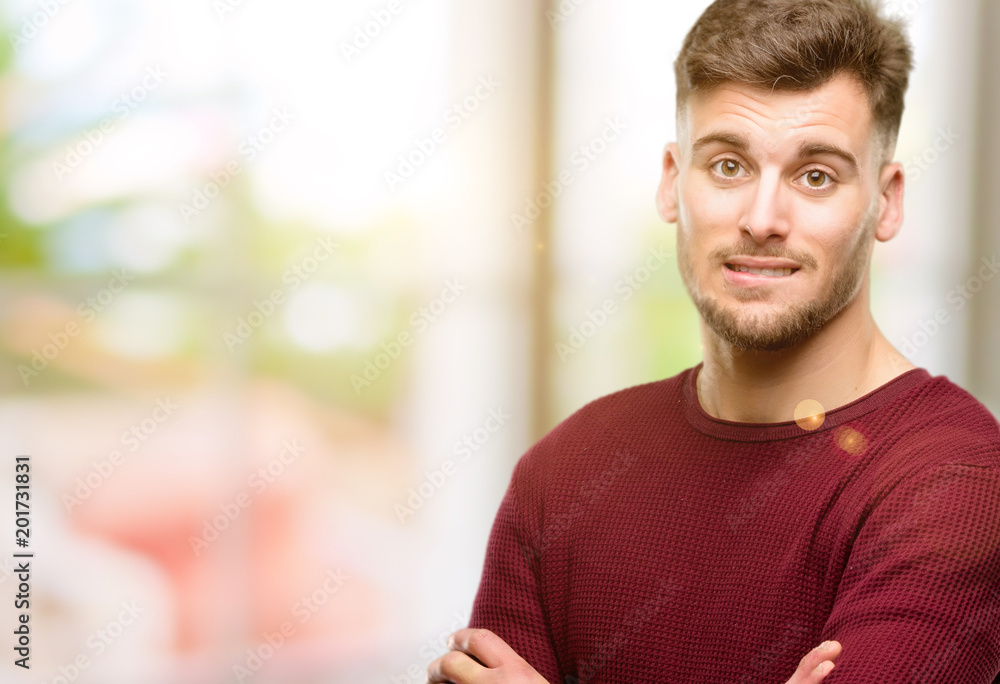 Handsome young man nervous and scared biting lips looking camera with impatient expression, pensive Handsome young man nervous and scared biting lips looking camera with impatient expression, pensive