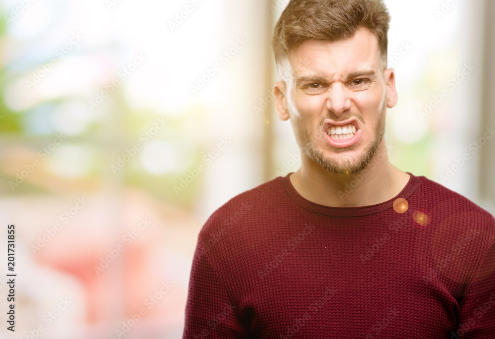 Handsome young man angry and stressful frowns face in dissatisfaction, irritated and annoyed, expressing anger Handsome young man angry and stressful frowns face in dissatisfaction, irritated and annoyed, expressing anger