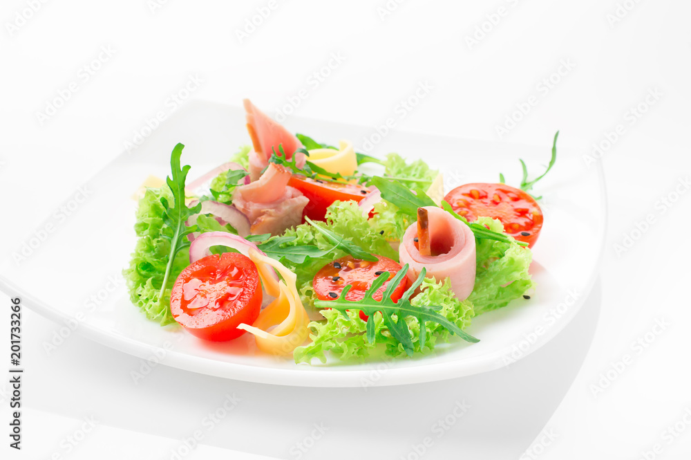Fresh salad with tomatoes, arugula, cheese and ham on the white plate and white background Fresh salad with tomatoes, arugula, cheese and ham on the white plate and white background