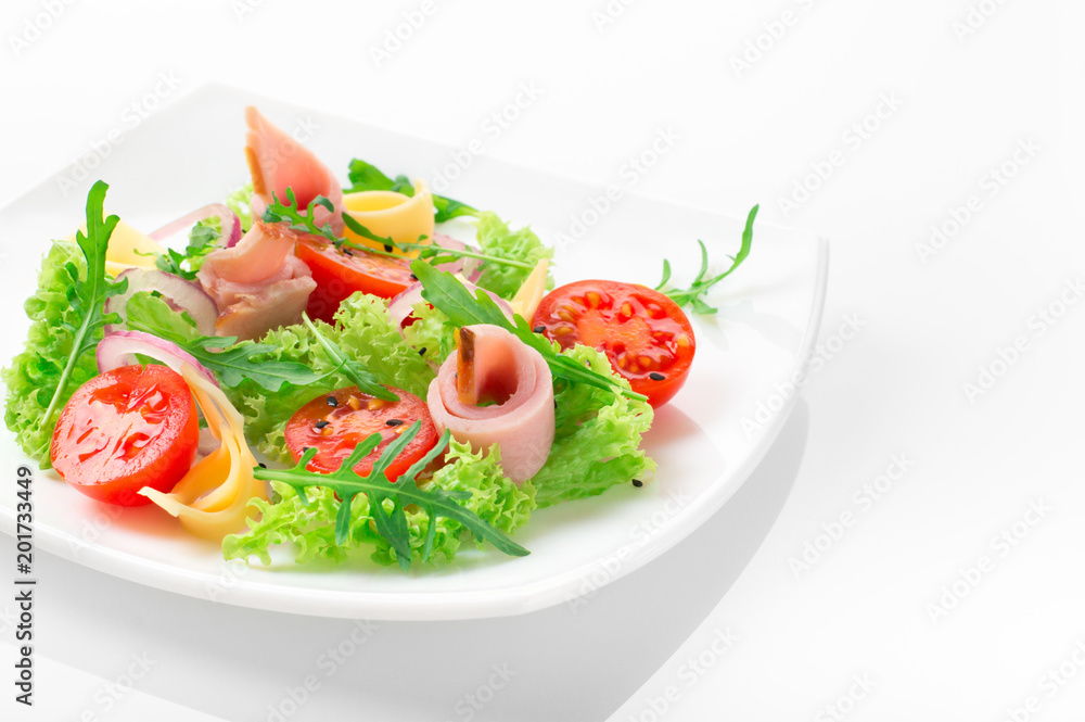 Fresh salad with tomatoes, arugula, cheese and ham on the white plate and white background