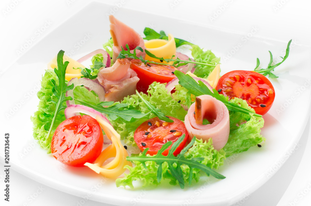 Fresh salad with tomatoes, arugula, cheese and ham on the white plate and white background Fresh salad with tomatoes, arugula, cheese and ham on the white plate and white background