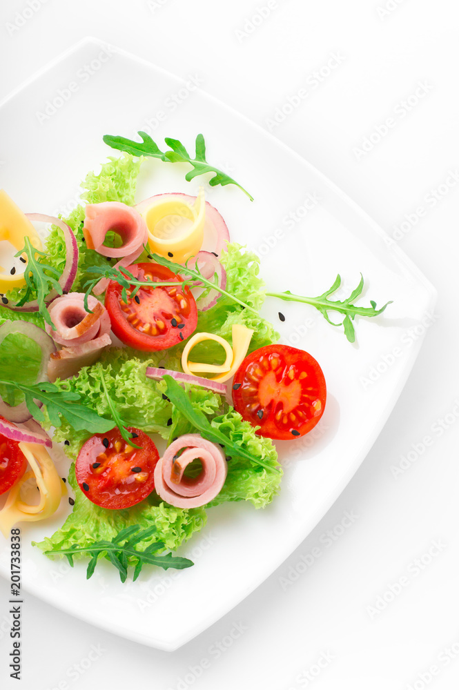 Fresh salad with tomatoes, arugula, cheese and ham on the white plate and white background Fresh salad with tomatoes, arugula, cheese and ham on the white plate and white background