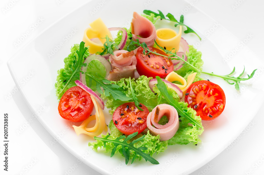 Fresh salad with tomatoes, arugula, cheese and ham on the white plate and white background