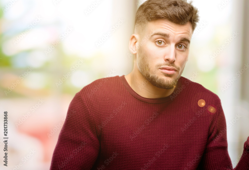 Handsome young man doubt expression, confuse and wonder concept, uncertain future Handsome young man doubt expression, confuse and wonder concept, uncertain future