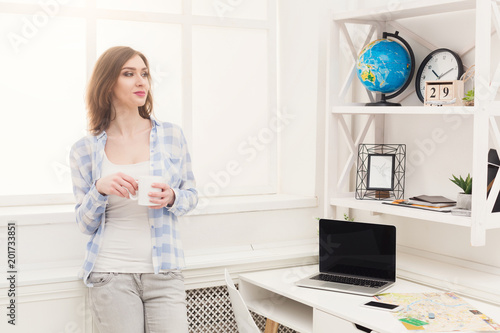 Woman dreaming about travel, looking at globe photo