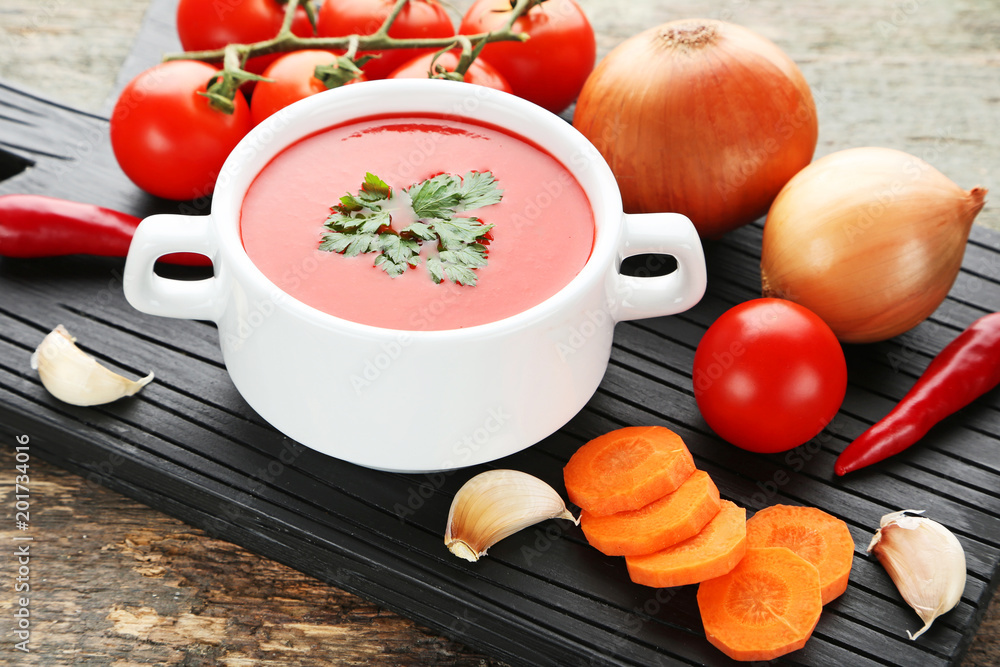 Tomato soup with parsley on grey wooden table Tomato soup with parsley on grey wooden table