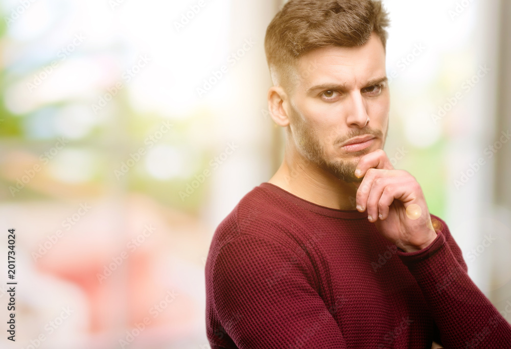 Handsome young man thinking thoughtful with smart face Handsome young man thinking thoughtful with smart face