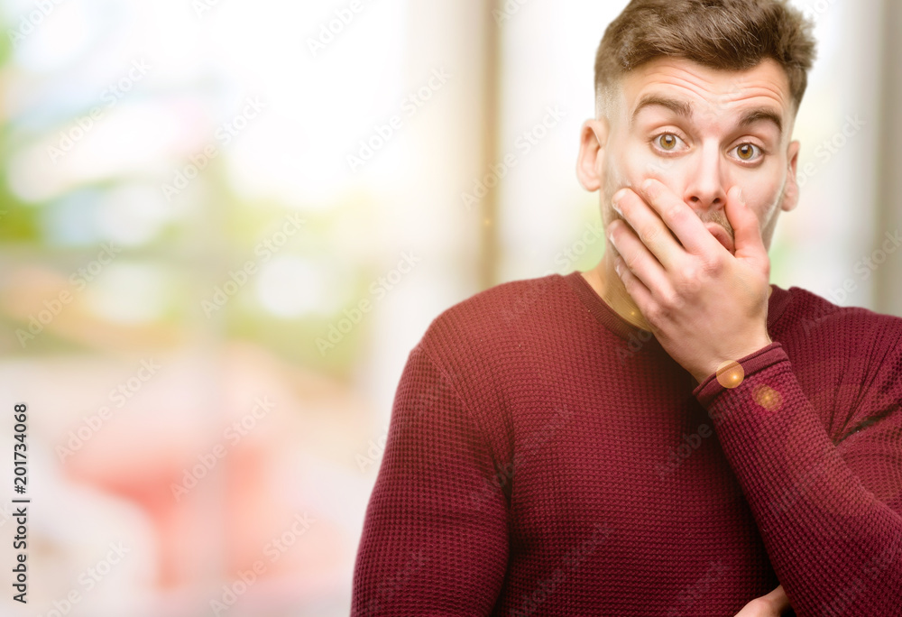 Handsome young man scared in shock, expressing panic and fear Handsome young man scared in shock, expressing panic and fear