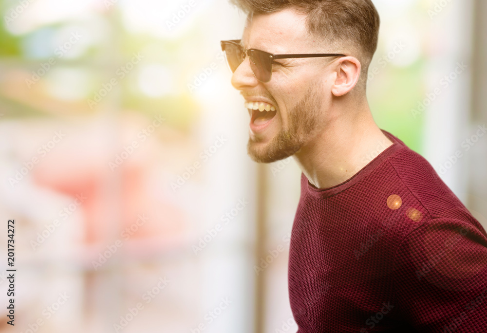 Handsome young man happy and excited celebrating victory expressing big success, power, energy and positive emotions. Celebrates new job joyful Handsome young man happy and excited celebrating victory expressing big success, power, energy and positive emotions. Celebrates new job joyful