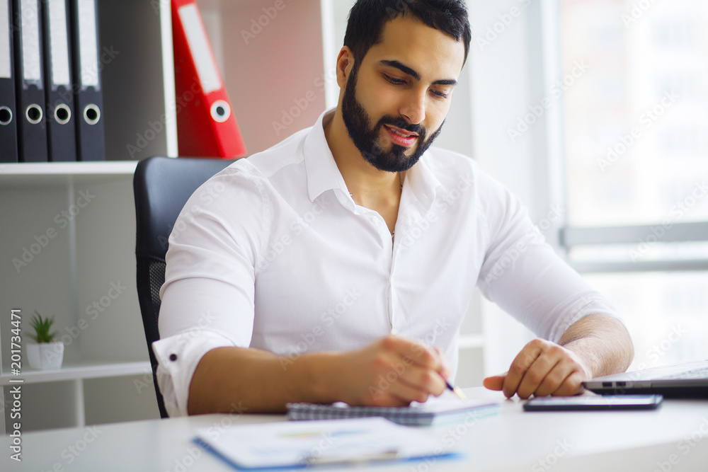 Fototapeta premium Happy successful businessman in a modern startup office indoors
