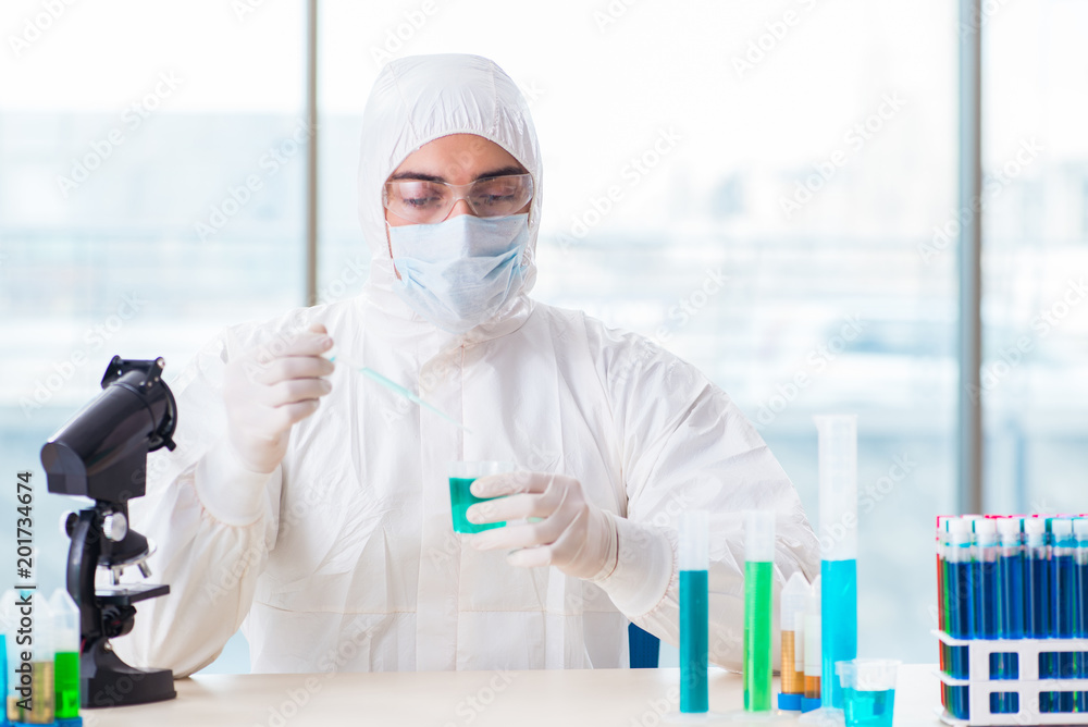 Young chemist student working in lab on chemicals Young chemist student working in lab on chemicals