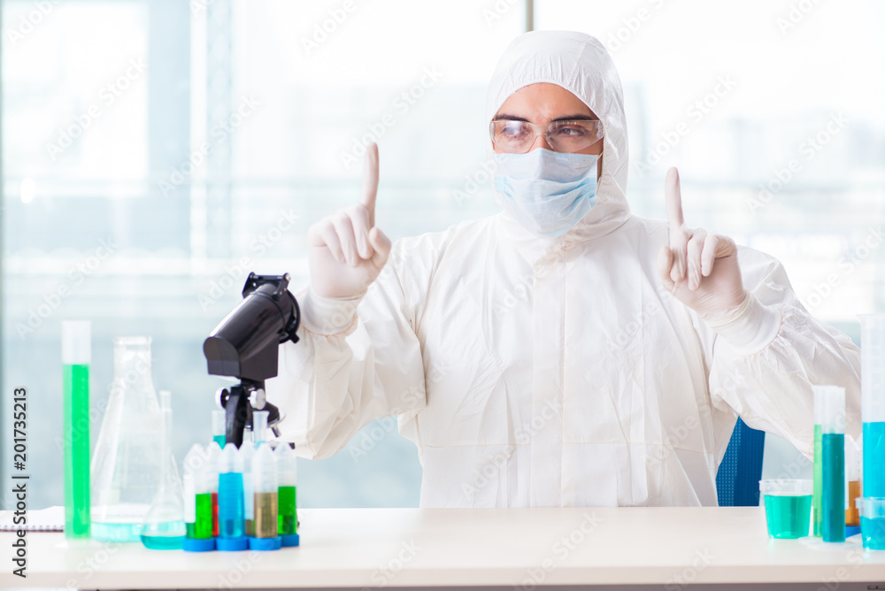 Young chemist pressing virtual buttons in lab Young chemist pressing virtual buttons in lab