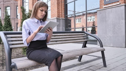 Tense Frustrated Woman Reaction, while Using tablet photo