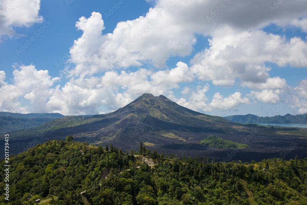 amazing panoramic scenery of kintamani volcano and surrounding with cloudy blue sky scene