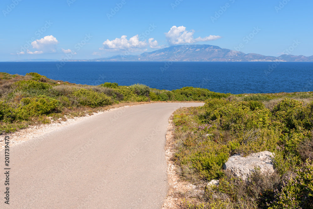 Road on Skinari cape with views across the sea to Kefalonia island, Zakynthos, Greece