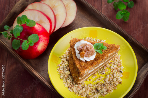Honey cake on a plate. Wooden rustic background