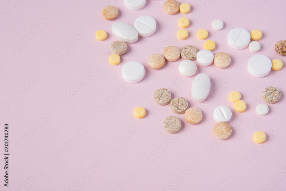 Different tablets and pill in the package and without it on a pink background Different tablets and pill in the package and without it on a pink background